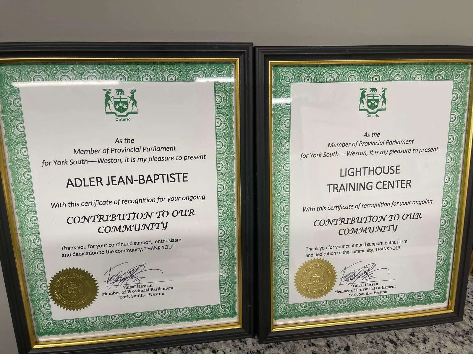 Two framed certificates of recognition from the Member of Provincial Parliament for York South-Weston, one to Lighthouse Training Center and one to Adler Jean-Baptiste