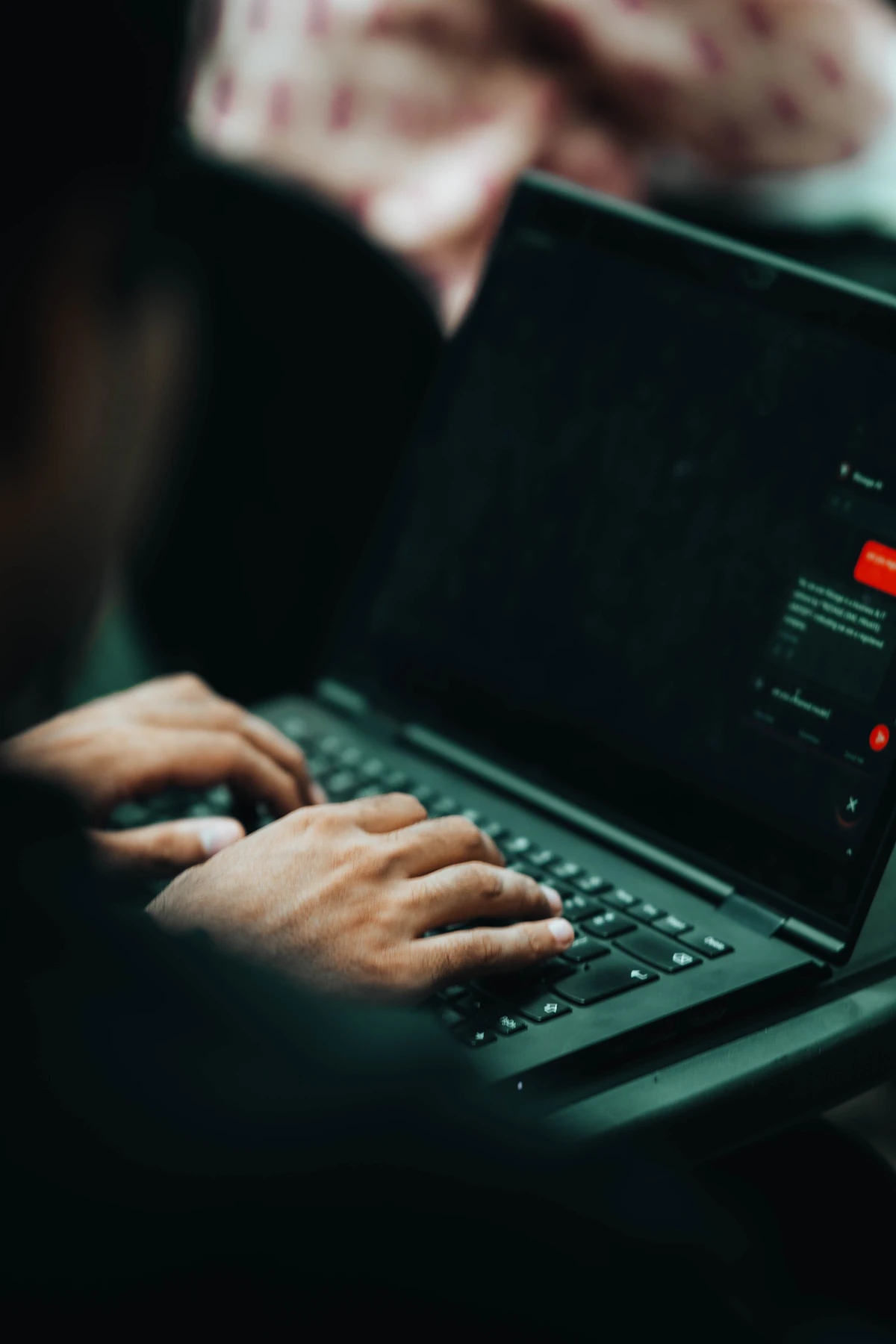 Two hands on a laptop keyboard